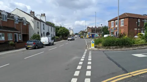 View down Wood Lane in Rothwell with homes either side of the road