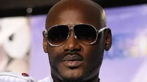 Getty Images A close-up picture of Tuface. He has a shaved head and is wearing dark glasses