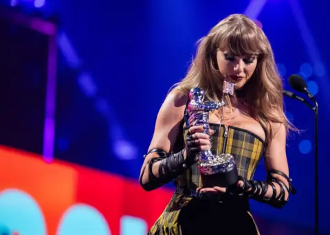 Getty Images Taylor Swift accepts an award at the 2024 MTV VMAs