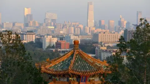 The Beijing skyline bathed in sunshine pictured from a hillside