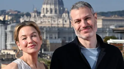 Bridget Jones actress Renée Zellweger and film director Michael Morris smile while looking into the camera