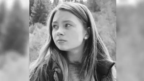 Family handout A black and white image of a young girl with her hair down looking to the right of the shot. 