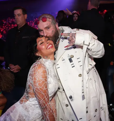 Getty Images Teddy Swims kisses his partner Raiche Wright on the forehead, as they attend the MTV Video Music Awards in September 2024