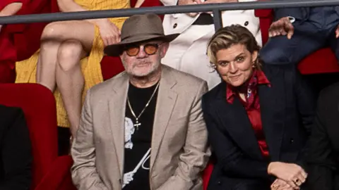 AMPAS Bernie Taupin and Brandi Carlile in the 97th Oscars nominees dinner class photo