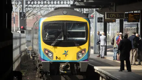 The front of a train as it sits at the platform 