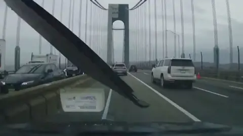 Screenshot from the driver's view: a piece of wood flies in right in front of the wind shield front window.