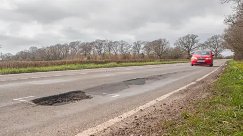 Getty Images A pothole on a fast rural road in the UK.