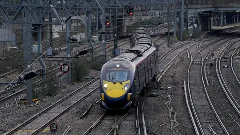 PA Media A blue Southeastern High Speed train leaves Ashford station in Kent