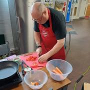 Lions president Roy Hallahan makes a casserole